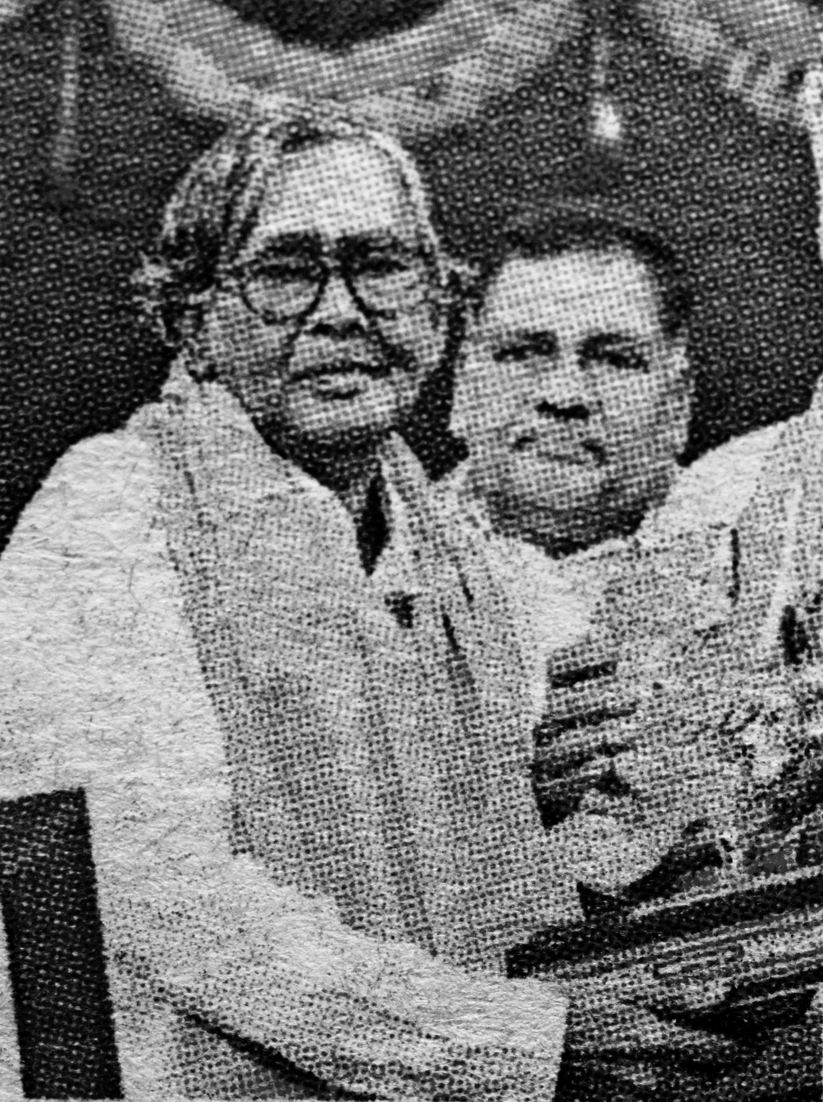 K.S. Vass seated with a trophy during a public recognition moment